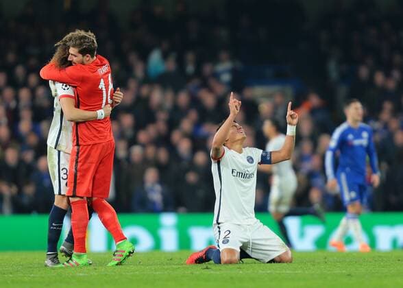 09.03.2016. Stamford Bridge, London, England. Champions League. Chelsea versus Paris Saint Germain. Paris St. Germain Defender Thiago Silva kneels and points to the sky after team mate Zlatan Ibrahimovic; makes it 2-1 PSG, and PSG Goalkeeper Kevin Trapp celebrates with David Luiz xMarkxKertonx  ActionPlus11715976