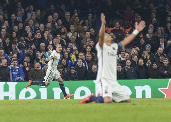 Football - 2015 2016 Champions League - Round of 16, Second Leg: Chelsea 1 vs. Paris Saint-Germain 2 Zlatan Ibrahimovic of PSG celebrates as Thiago Silvao of PSG sinks to his kness as PSG take a 2-1 lead at Stamford Bridge. COLORSPORT DANIEL BEARHAM  che_psg
