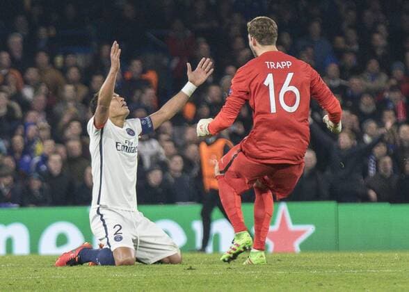 Football - 2015 2016 Champions League - Round of 16, Second Leg: Chelsea 1 vs. Paris Saint-Germain 2 Kevin Trapp of PSG rushes to celebrate with team mate Thiago Silva at Stamford Bridge. COLORSPORT DANIEL BEARHAM  che_psg