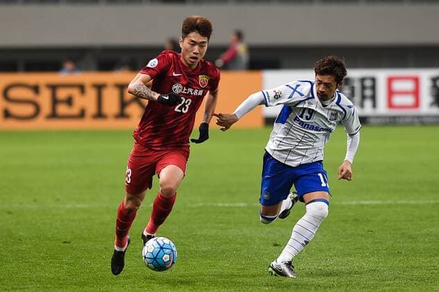 SHANGHAI, CHINA - MARCH 15: (CHINA OUT) Fu Huan 23 of Shanghai SIPG and Kotaro Omori 19 of Gamba Osaka compete for the ball during the AFC Champions League Group G match between Shanghai SIPG and Gamba Osaka at Shanghai Stadium on March 15, 2016 in Shanghai, China.  CFP481171276 