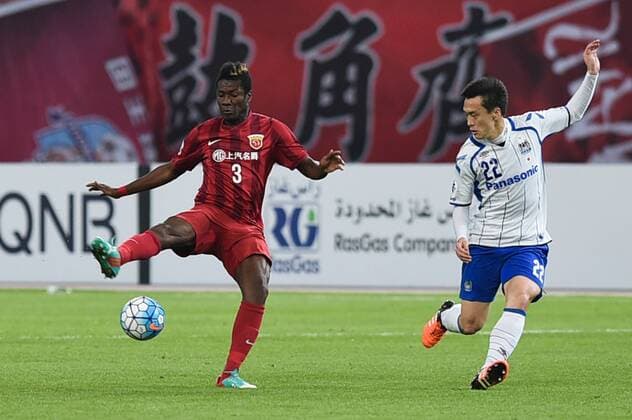SHANGHAI, CHINA - MARCH 15: (CHINA OUT) Asamoah Gyan 3 of Shanghai SIPG and Oh Jae-suk 22 of Gamba Osaka compete for the ball during the AFC Champions League Group G match between Shanghai SIPG and Gamba Osaka at Shanghai Stadium on March 15, 2016 in Shanghai, China.  CFP481171277 