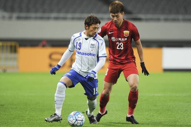 SHANGHAI, CHINA - MARCH 15: (CHINA OUT) Fu Huan 23 of Shanghai SIPG and Kotaro Omori 19 of Gamba Osaka compete for the ball during the AFC Champions League Group G match between Shanghai SIPG and Gamba Osaka at Shanghai Stadium on March 15, 2016 in Shanghai, China.  CFP481172932 
