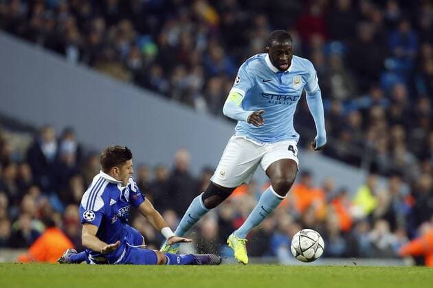 Yaya Toure of Manchester City skips past a tackle by Kiev s Aleksandar Dragovic during the UEFA Champions League match at the Etihad Stadium. Photo credit should read: Philip Oldham Sportimage EDITORIAL USE ONLY. No use with unauthorised audio, video, data, fixture lists, club league logos or live services. Online in-match use limited to 120 images, no video emulation. No use in betting, games or single club league player publications.
