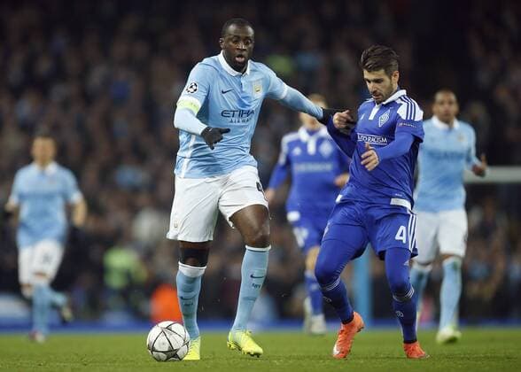 Yaya Toure of Manchester City battles Kiev s Miguel Veloso during the UEFA Champions League match at the Etihad Stadium. - PhilipxOldham Sportimage EDITORIAL USE ONLY. No use with unauthorised audio, video, data, fixture lists, club league logos or live services. Online in-match use limited to 120 images, no video emulation. No use in betting, games or single club league player publications.