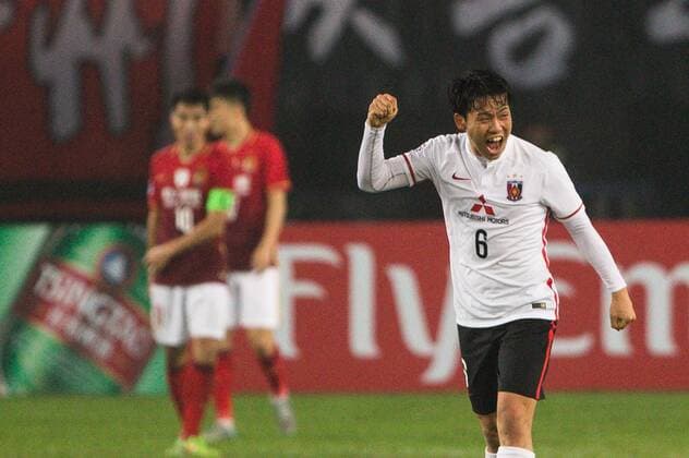 GUANGZHOU, CHINA - MARCH 16: (CHINA OUT) Wataru Endo 6 of Urawa Red Diamonds celebrates after team mate Shinzoh Kohrogi scored his team s second goal during the AFC Champions League Group H match between Guangzhou Evergrande and Urawa Red Diamonds at Tianhe Center on March 16, 2016 in Guangzhou, China.  CFP481236762 
