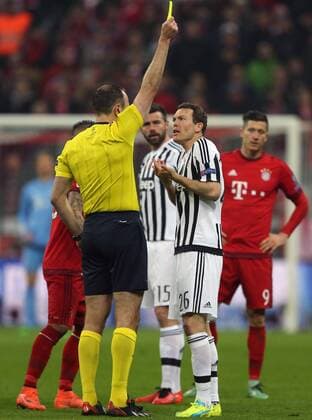 SOCCER - CL, Bayern vs Juventus MUNICH,GERMANY,16.MAR.16 - SOCCER - UEFA Champions League, Round of 16, FC Bayern Muenchen vs Juventus Turin. Image shows referee Jonas Eriksson (SWE) and Stephan Lichtsteiner (Juventus). Keywords: yellow card. GEPAxpictures xThomasxBachun