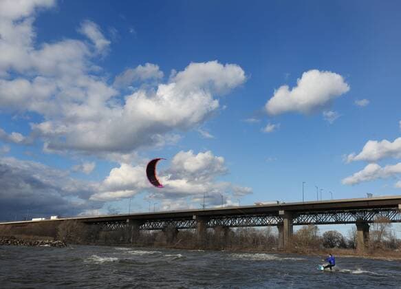 March 16, 2016 - Hamilton, ON, CAN - Kristian Wolf, 29, of Burlington, takes advantage of the warmer weather and high afternoon winds to kite board on Hamilton Harbour in Hamilton, Ontario on March 16, 2016. Kite Boarding Hamilton Harbour - ZUMAp131