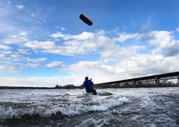 March 16, 2016 - Hamilton, ON, CAN - Kristian Wolf, 29, of Burlington, takes advantage of the warmer weather and high afternoon winds to kite board on Hamilton Harbour in Hamilton, Ontario on March 16, 2016. Kite Boarding Hamilton Harbour - ZUMAp131