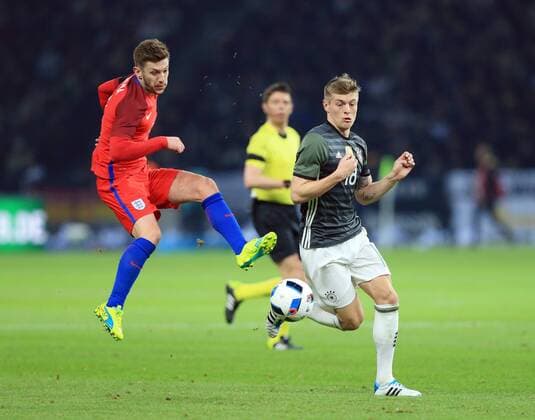 Germany s Toni Kroos tussles with England s Adam Lallana during the International Friendly Länderspiel match at Olympiastadion. Photo credit should read: David Klein Sportimage EDITORIAL USE ONLY. No use with unauthorised audio, video, data, fixture lists, club league logos or live services. Online in-match use limited to 120 images, no video emulation. No use in betting, games or single club league player publications.