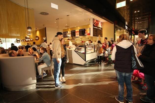 Chemnitz, 26.03.2016, Höfe am Brühl, Fussball, 3. Liga, Daniel Frahn Spieler des Chemnitzer FC eröffnet mit Henrik Ernst und Christian Müller in Leipzig das Eiscafe La Luna. , Im Bild: Daniel Frahn im Cafe, umringt von Fans. ,