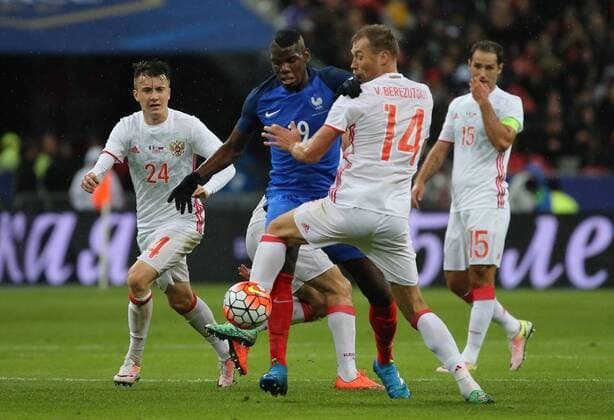 SAINT-DENIS, FRANCE. MARCH 29, 2016. Russia s Alexander Golovin, France s Paul Pogba, Russia s Vasili Berezutski and Roman Shirokov (L-R) fight for the ball in their friendly football match at the Stade de France. Alexander Demianchuk TASS  TS01DDF7