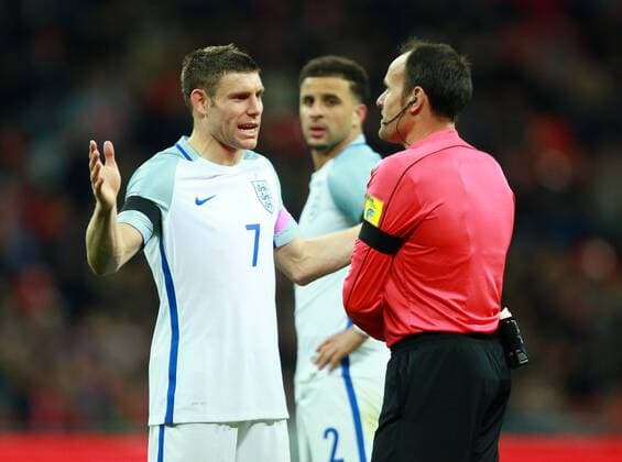 England v Netherlands . . Wembley, London, UK . . 29.03.2016 James Milner (E) speaks to Antonio Miguel Mateu Lahoz about the penalty decision, with Kyle Walker (E) in the background. 