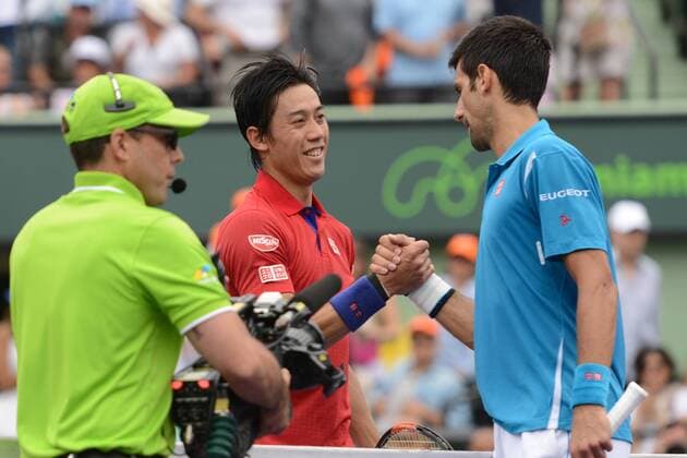 April 3, 2016 - Miami, Florida, United States - NOVAK DJOKOVIC and KEI NISHIKORI meet at the net at the Miami Open. Tennis 2016 - Miami Open - Day 14 - ZUMAl132