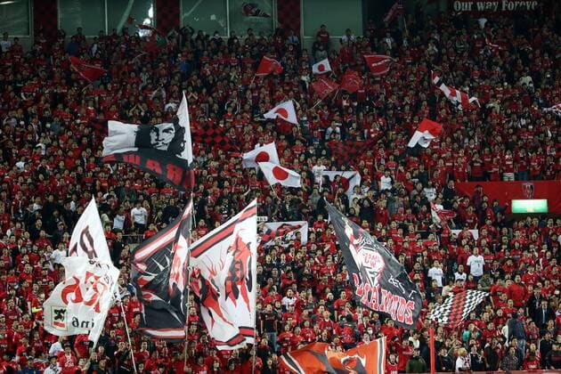 Japanese football fans wave flags and shout slogans to show support for Japan s Urawa Red Diamonds in their Group G match against China s Guangzhou Evergrande during the AFC Champions League 2016 in Saitama, Japan, 5 April 2016. Urawa Red Diamonds vs Guangzhou Evergrande at AFC Champions League  20160405_32202