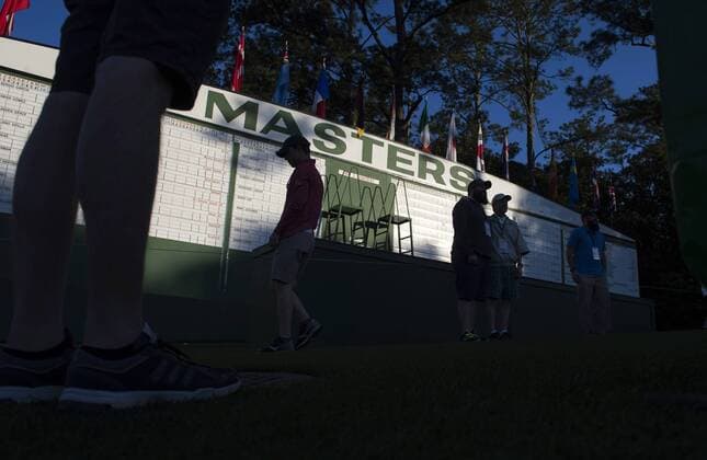 Patrons gather near the Masters scoreboard during a practice round before the 2016 Masters Tournament at Augusta National in Augusta, Georgia on April 5, 2016.  AUG20160405302 KEVINxDIETSCH