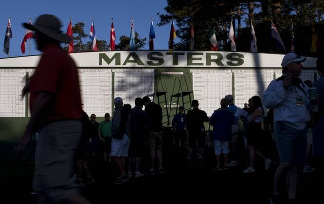 Patrons gather near the Masters scoreboard during a practice round before the 2016 Masters Tournament at Augusta National in Augusta, Georgia on April 5, 2016.  AUG20160405305 KEVINxDIETSCH
