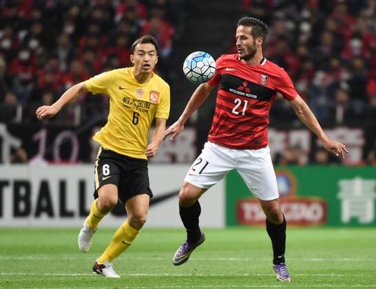 (160405) -- SAITAMA, April 5, 2016 -- Feng Xiaoting (L) of China s Guangzhou Evergrandtaobao vies with Zlatan Ljubijankic of Japan s Urawa Red Diamonds during the AFC Champions League Group H football match in Saitama, Japan, April 5, 2016. ) (SP)JAPAN-SAITAMA-FOOTBALL-AFC CHAMPIONS LEAGUE LiuxDawei 