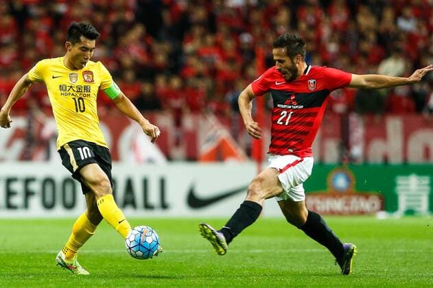 SAITAMA, JAPAN - APRIL 05: (CHINA OUT) Zheng Zhi 10 of Guangzhou Evergrande and Zlatan Ljubijankic 21 of Urawa Red Diamonds compete for the ball during the AFC Champions League Group H match between Urawa Red Diamonds and Guangzhou Evergrande at the Saitama Stadium on April 5, 2016 in Saitama, Japan.  CFP482263911 
