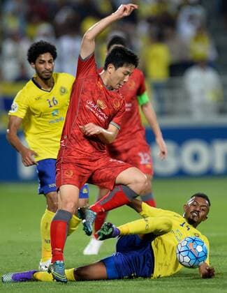 (160406) -- DOHA, April 6, 2016 -- Ibrahim Ghaleb (Bottom) of Saudi Arabia s Al-Nassr fights for the ball against Nam Tae-Hee of Qatar s Lekhwiya during the AFC Asian Champions League group B football match at Lekhwiya stadium, in Doha, Qatar, on April 05, 2016. Qatar s Lekhwiya won 4-0. ) (SP)QATAR-DOHA-FOOTBALL-AFC CHAMPIONS LEAGUE Nikku 