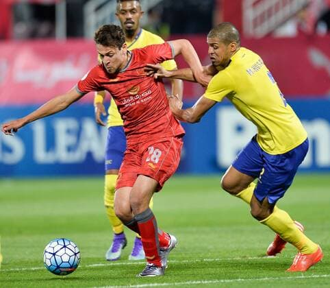(160406) -- DOHA, April 6, 2016 -- Youssef Msakni (L) of Qatar s Lekhwiya fights for the ball against Mohamed Husain (R) of Saudi Arabia s Al-Nassr during the AFC Asian Champions League group B football match at Lekhwiya stadium, in Doha, Qatar on April 05, 2016. Qatar s Lekhwiya won 4-0. ) (SP)QATAR-DOHA-FOOTBALL-AFC CHAMPIONS LEAGUE Nikku 