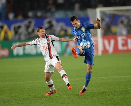 Trent Sainsbury of China s Jiangsu Suning, right, challenges Nathan Burns of Japans FC Tokyo in their Group E match during the AFC Champions League 2016 in Nanjing city, east China s Jiangsu province, 6 April 2016. Jiangsu Suning vs FC Tokyo at AFC Champions League  20160406_34038