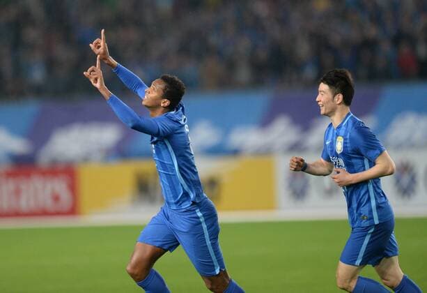 Joao Alves of China s Jiangsu Suning, left, celebrates after scoring a goal by a penalty shot against Japans FC Tokyo in their Group E match during the AFC Champions League 2016 in Nanjing city, east China s Jiangsu province, 6 April 2016. Jiangsu Suning vs FC Tokyo at AFC Champions League  20160406_11678