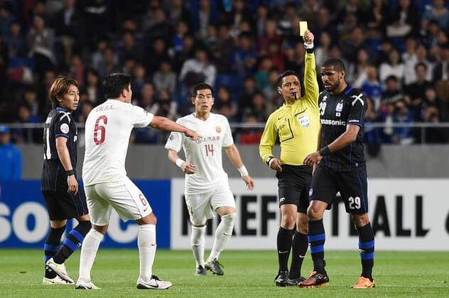 OSAKA, JAPAN - APRIL 06: (CHINA OUT) Patric 29 of Gamba Osaka receives a yellow card from the referee during the AFC Champions League Group G match between Gamba Osaka and Shanghai SIPG at Suita City Stadium on April 6, 2016 in Osaka, Japan.  CFP482304723 