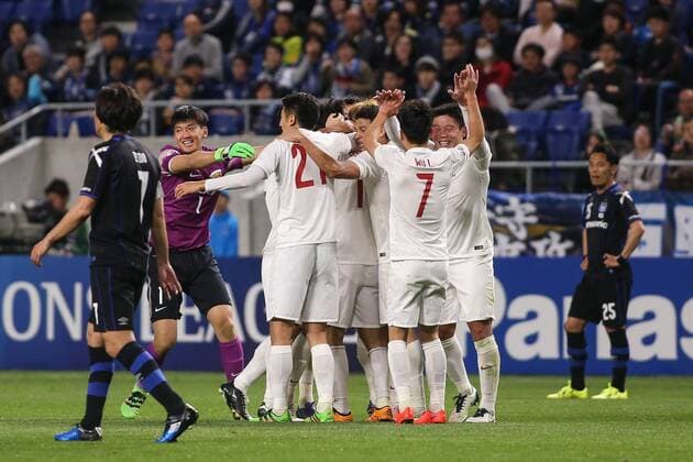OSAKA, JAPAN - APRIL 06: (CHINA OUT) Lu Wenjun 11 of Shanghai SIPG celebrates with team mates after scoring his team s second goal during the AFC Champions League Group G match between Gamba Osaka and Shanghai SIPG at the Suita City Football Stadium on April 6, 2016 in Osaka, Japan.  CFP482306154 
