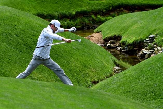 April 6, 2016 - Augusta, GA, USA - Zach Johnson jumps over a stream at the 13th green during a practice round on Wednesday, April 6, 2016, at Augusta National Golf Club in Augusta, Ga. First round action of The Masters tournament begins on Thursday. Masters practice - ZUMAm67_