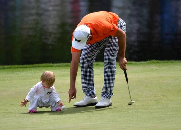 Billy Horschel and his daughter Skyler put the ball in the hole on the ninth green during the Par Three Contest at the 2016 Masters Tournament at Augusta National in Augusta, Georgia on April 6, 2016.  AUG20160406337 KEVINxDIETSCH