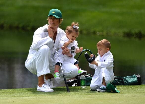 Bubba Watson s wife Angie, sits with their children, Caleb and Dakota on the ninth hole during the Par Three Contest at the 2016 Masters Tournament at Augusta National in Augusta, Georgia on April 6, 2016.  AUG20160406309 KEVINxDIETSCH