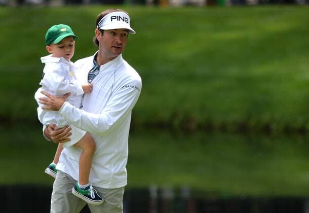 Bubba Watson holds his son Caleb on the ninth hole during the Par Three Contest at the 2016 Masters Tournament at Augusta National in Augusta, Georgia on April 6, 2016.  AUG20160406312 KEVINxDIETSCH