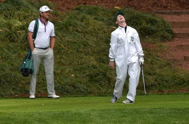 Grgraeme McDowell watches as his honorary caddie Army Corporal Kevin McCloskey, who lost both of his legs in a Taliban attack in 2008, reacts after hitting off of the ninth tee during the Par Three Contest at the 2016 Masters Tournament at Augusta National in Augusta, Georgia on April 6, 2016.  AUG20160406347 KEVINxDIETSCH