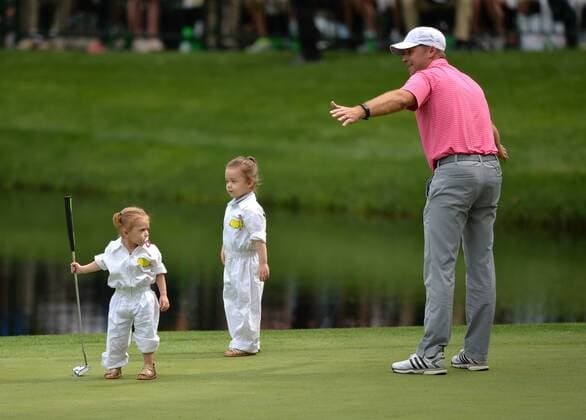 Sammy Schmitz talks to his daughters Aubree, 3, and Allie, 1, during the Par Three Contest at the 2016 Masters Tournament at Augusta National in Augusta, Georgia on April 6, 2016.  AUG20160406364 KEVINxDIETSCH