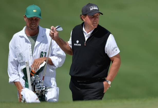 Phil Mickelson stands next to caddie Jim Mackay after he hits out of a bunker to the 7th green in the first round of the 2016 Masters Tournament at Augusta National in Augusta, Georgia on April 7, 2016.  MAS20160407155 KEVINxDIETSCH
