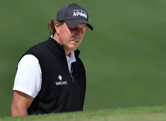 Phil Mickelson reacts after he hits out of a bunker to the 7th green in the first round of the 2016 Masters Tournament at Augusta National in Augusta, Georgia on April 7, 2016.  MAS20160407156 KEVINxDIETSCH