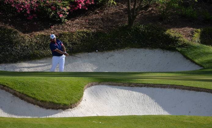 Shane Lowry of Ireland hits out of a sand trap on the 12th green in the first round of the 2016 Masters Tournament at Augusta National in Augusta, Georgia on April 7, 2016.  AUG20160407309 KEVINxDIETSCH