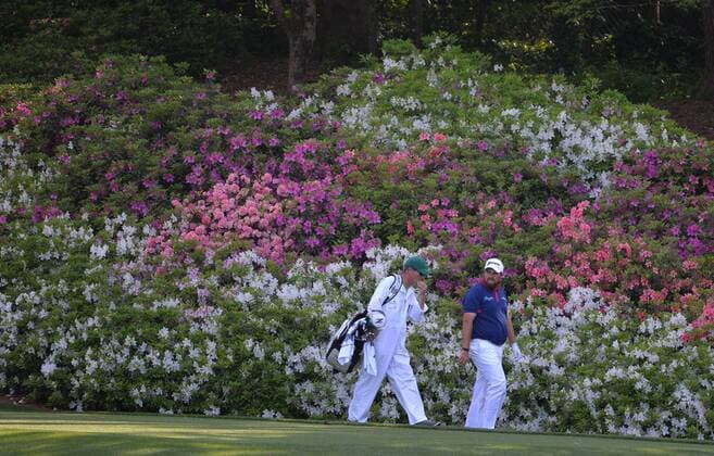 Shane Lowry of Ireland and his caddie Dermot Byrne walk to the 13th fairway in the first round of the 2016 Masters Tournament at Augusta National in Augusta, Georgia on April 7, 2016.  AUG20160407308 KEVINxDIETSCH