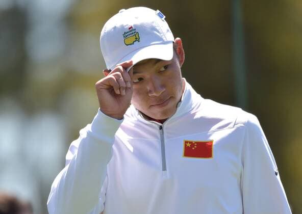 Cheng Jin of China tips his hat on the first hole tee box in the second round of the 2016 Masters Tournament at Augusta National in Augusta, Georgia on April 8, 2016.  MAS20160408124 KEVINxDIETSCH