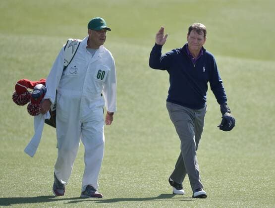 Caddie Neil Oxman walks with Tom Watson who waves and reacts to the crowds ovation as he walks up the fairway to the 18th green in the second round of the 2016 Masters Tournament at Augusta National in Augusta, Georgia on April 8, 2016. Tom Watson missed the cut with a score of 8 over par in his last ever Masters.  MAS20160408168 KEVINxDIETSCH