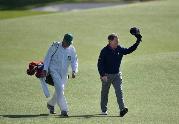 Caddie Neil Oxman walks with Tom Watson who tips his hat and reacts to the crowds ovation as he walks up the fairway to the 18th green in the second round of the 2016 Masters Tournament at Augusta National in Augusta, Georgia on April 8, 2016. Tom Watson missed the cut with a score of 8 over par in his last ever Masters.  MAS20160408169 KEVINxDIETSCH