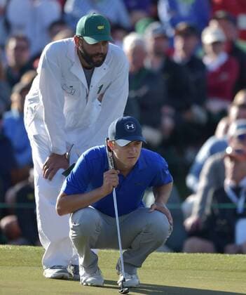 Caddie Michael Greller and Jordan Spieth line up a putt on the 18th green in the second round of the 2016 Masters Tournament at Augusta National in Augusta, Georgia on April 8, 2016.  MAS20160408176 KEVINxDIETSCH