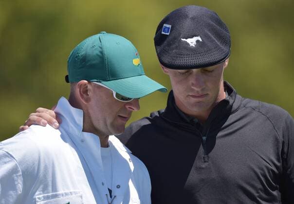 Bryson DeChambeau puts his arm around caddie Drew Hinesley on the first hole tee box in the third round of the 2016 Masters Tournament at Augusta National in Augusta, Georgia on April 9, 2016.  MAS20160409123 KEVINxDIETSCH