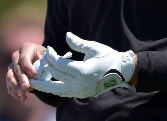 Bryson DeChambeau holds a marked golf ball on the first hole tee box in the third round of the 2016 Masters Tournament at Augusta National in Augusta, Georgia on April 9, 2016.  MAS20160409122 KEVINxDIETSCH