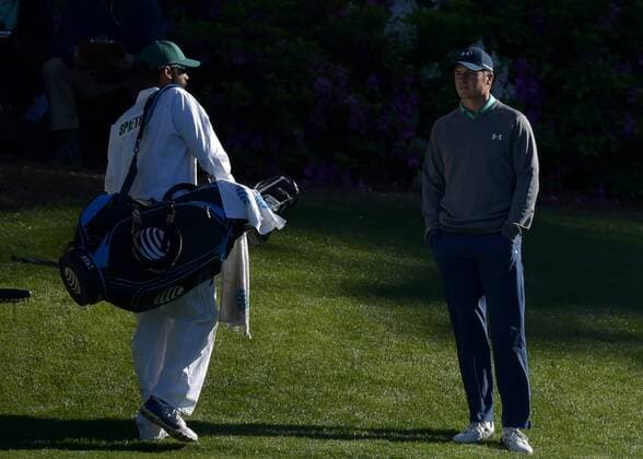 Caddie Michael Greller and Jordan Spieth stand near the tee box on the 13th hole in the third round of the 2016 Masters Tournament at Augusta National in Augusta, Georgia on April 9, 2016.  MAS20160409143 KEVINxDIETSCH