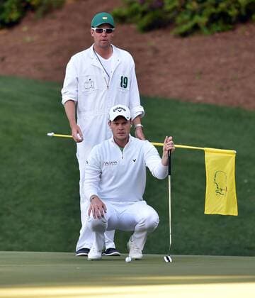 April 10, 2016 - Augusta, GA, USA - Danny Willett and his caddie Jonathan Smart line up a putt on the 13th green during the final round of the Masters on Sunday, April 10, 2016, at Augusta National Golf Club in Augusta, Ga. Masters final round - ZUMAm67_
