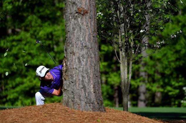 April 10, 2016 - Augusta, GA, USA - Smylie Kaufman peers around a tree after hitting his ball from the area along the 11th fairway during the final round of the Masters on Sunday, April 10, 2016, at Augusta National Golf Club in Augusta, Ga. Masters final round - ZUMAm67_