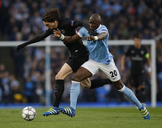Gregory van der Wiel of Paris Saint Germain tussles with Eliaquim Mangala of Manchester City during the UEFA Champions League match at The Etihad Stadium. Photo credit should read: Simon Bellis Sportimage EDITORIAL USE ONLY. No use with unauthorised audio, video, data, fixture lists, club league logos or live services. Online in-match use limited to 120 images, no video emulation. No use in betting, games or single club league player publications.