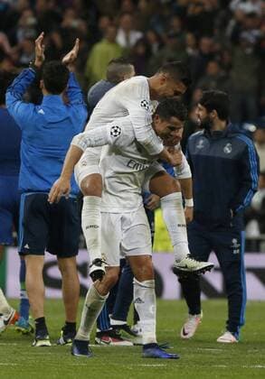 Real Madrid Portuguese forward Cristiano Ronaldo (down) celebrates the qualification with Brazilian team mate Casemiro during a Champions League quarter final second leg match between Real Madrid and Wolfsburg held at Santiago Bernabeu Stadium in Madrid, Spain, 12 April 2016. REAL MADRID VS WOLFSBURGO !ACHTUNG: NUR REDAKTIONELLE NUTZUNG!  RMD041 20160412-635960996569291151