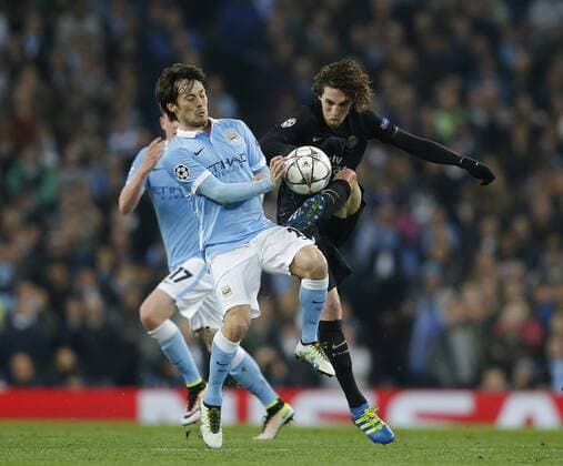 David Silva of Manchester City tussles with Gregory van der Wiel of Paris Saint Germain during the UEFA Champions League match at The Etihad Stadium. Photo credit should read: Simon Bellis Sportimage EDITORIAL USE ONLY. No use with unauthorised audio, video, data, fixture lists, club league logos or live services. Online in-match use limited to 120 images, no video emulation. No use in betting, games or single club league player publications.